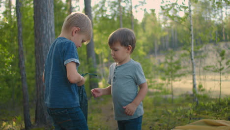 Zwei-Kleine-Jungen-Im-Wald-Helfen-In-Zeitlupe-Beim-Auslegen-Und-Aufbauen-Eines-Zeltes
